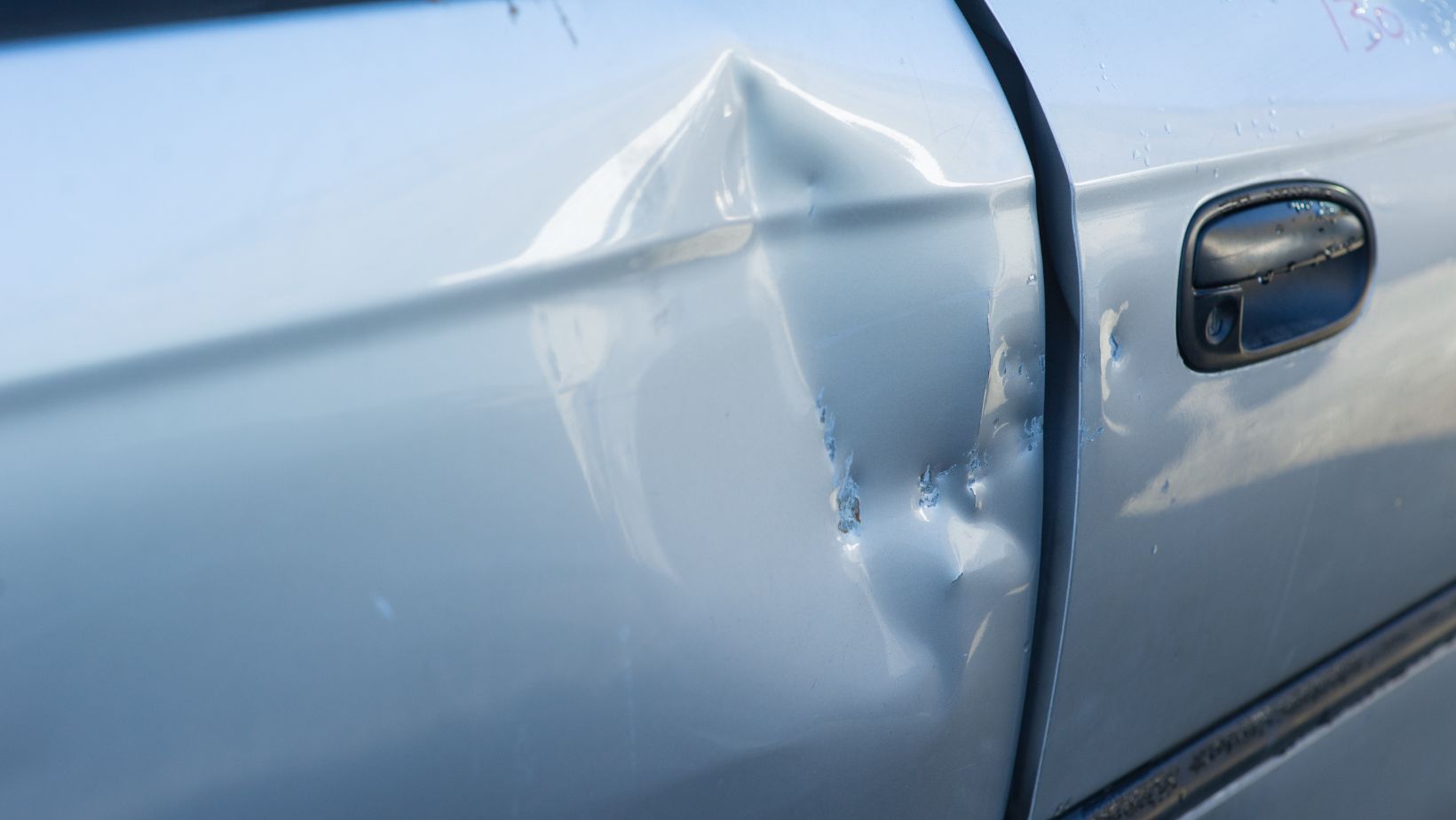 car door damage repair or replace